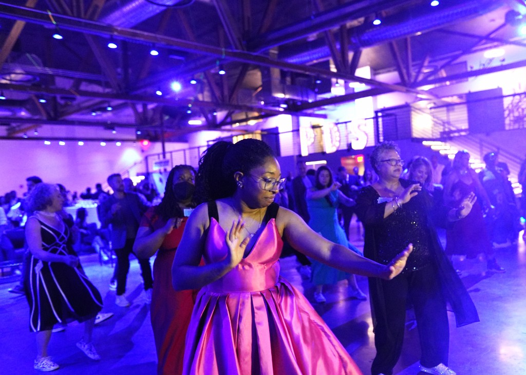 Corporate gala with guests dancing under purple and blue lighting