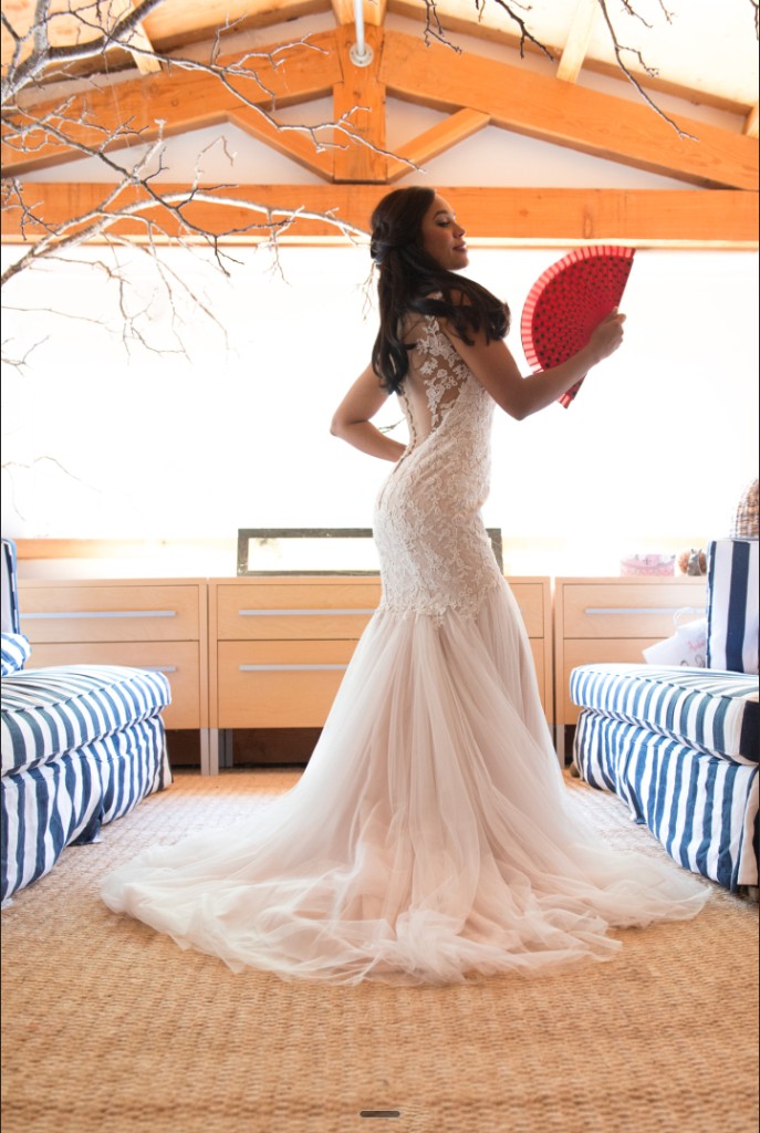 Bride in wedding gown with red fan